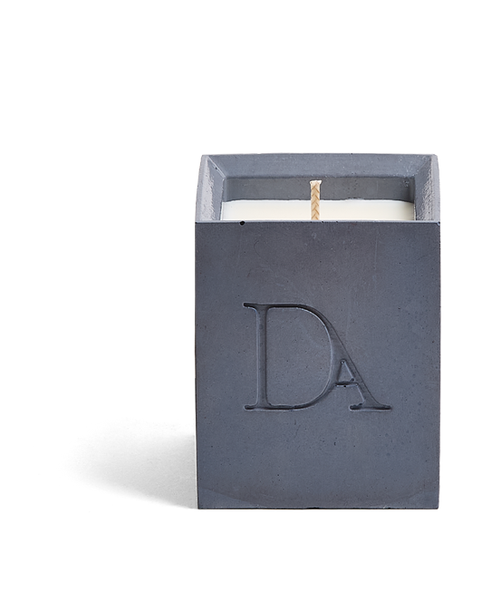 4oz Devetu artisanal candle in Elysian, crafted in a deep navy concrete square vessel. The candle is uncovered, displaying the richly textured wax surface, with the 'DA' Devetu Aroma logo embossed on the front.