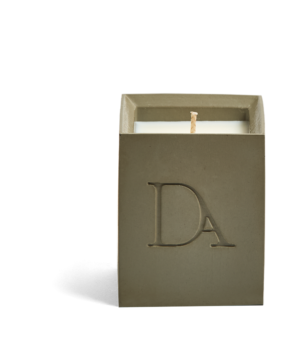 4oz Devetu artisanal concrete square candle named Wild Nomad, uncovered, showcasing the richly textured wax surface, in a deep olive green with ‘DA’ Devetu Aroma logo embossed on the front