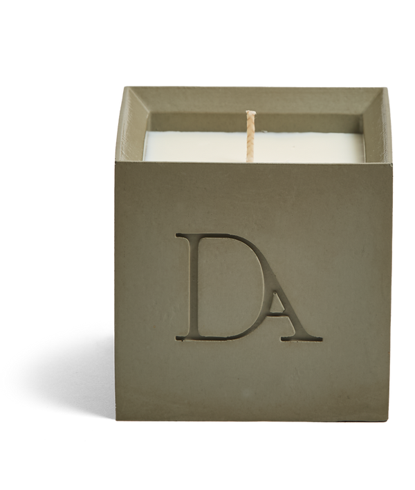 9oz Devetu artisanal concrete square candle named Wild Nomad, uncovered, showcasing the richly textured wax surface, in a deep olive green with ‘DA’ Devetu Aroma logo embossed on the front