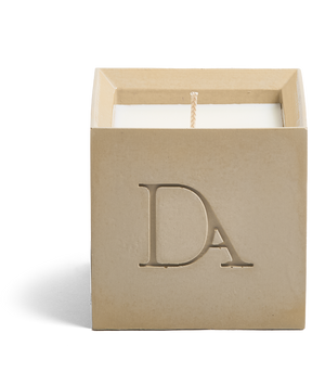 9oz Devetu artisanal concrete square candle named Gravity in soft taupe, uncovered, showcasing the richly textured wax surface, with ‘DA’ Devetu Aroma logo embossed on the front.