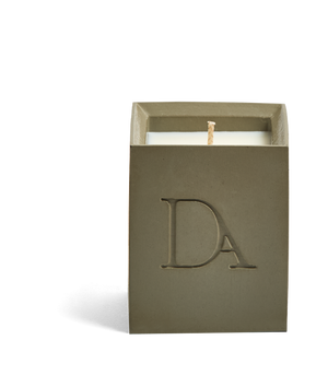 4oz Devetu artisanal concrete square candle named Wild Nomad, uncovered, showcasing the richly textured wax surface, in a deep olive green with ‘DA’ Devetu Aroma logo embossed on the front