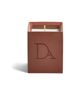 4oz Devetu artisanal concrete square candle named Phoenix in burnt red, uncovered, showcasing the richly textured wax surface, with ‘DA’ Devetu Aroma logo embossed on the front.