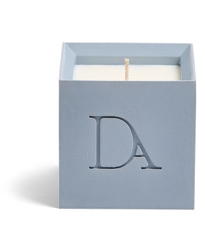 9oz Devetu artisanal candle in Muse, crafted in a powder blue concrete square vessel. The candle is uncovered, displaying the richly textured wax surface, with the 'DA' Devetu Aroma logo embossed on the front.