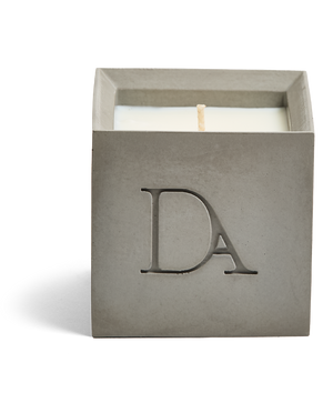 9oz Devetu artisanal concrete square candle named Odyssey in ash grey, uncovered, showcasing the richly textured wax surface, with ‘DA’ Devetu Aroma logo embossed on the front.