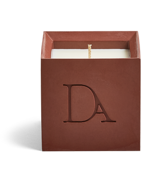 9oz Devetu artisanal concrete square candle named Phoenix in burnt red, uncovered, showcasing the richly textured wax surface, with ‘DA’ Devetu Aroma logo embossed on the front.