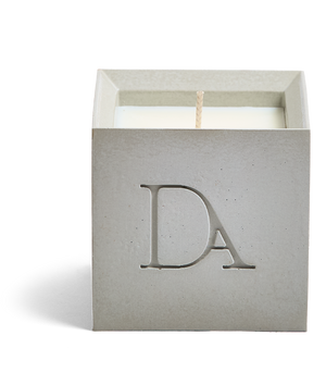 9oz Devetu artisanal concrete square candle named Skin, uncovered, showcasing the richly textured wax surface, in natural concrete with ‘DA’ Devetu Aroma logo embossed on the front.